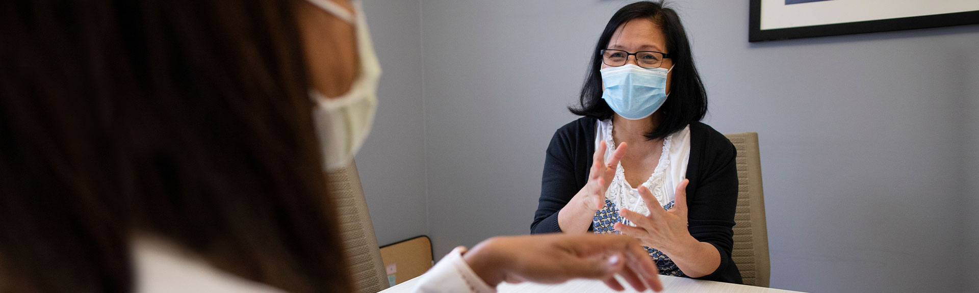 Doctor and patient wearing masks during a consultation